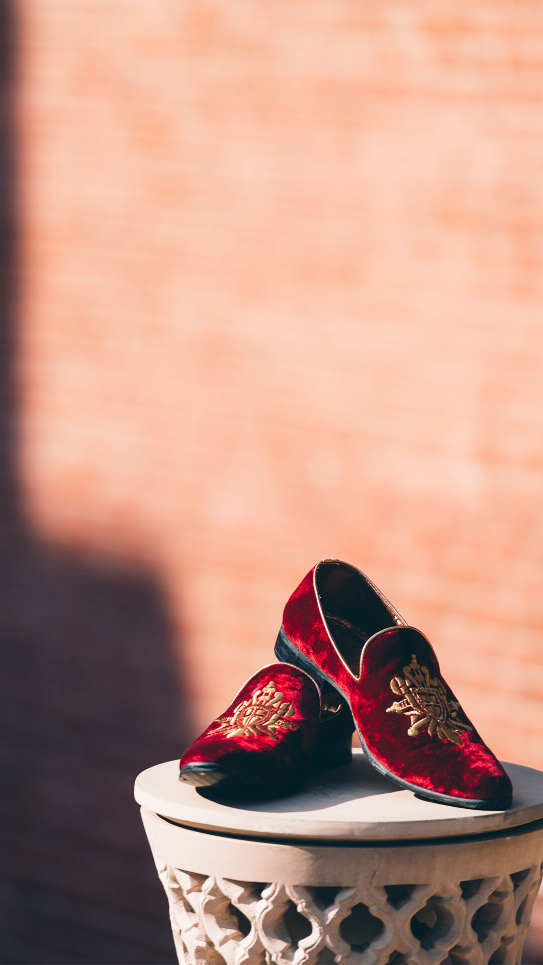 Embroidered red juttis perfect for wedding festivities.